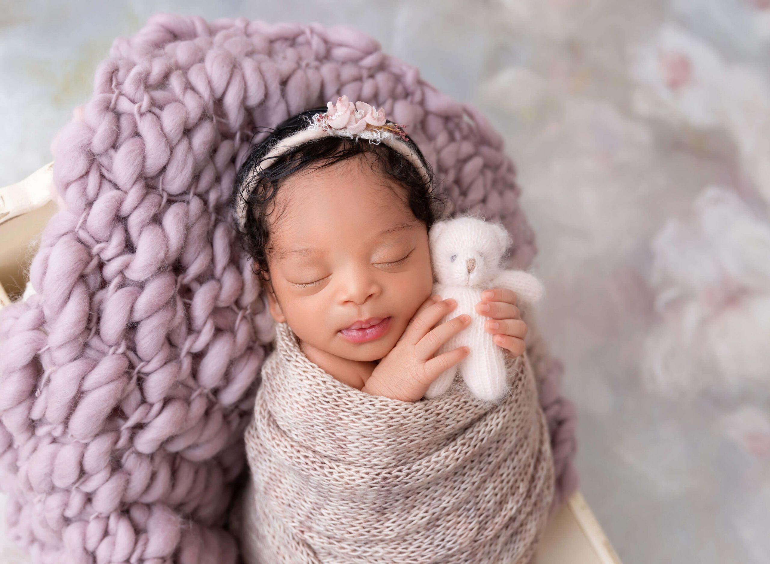 baby girl holding tiny bear newborn photoshoot at Rochel konik Photography Newborn Photographer NYC