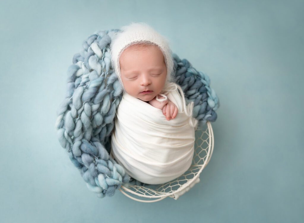 Newborn baby boy with a bonnet portraits teal ivory Brooklyn NYC