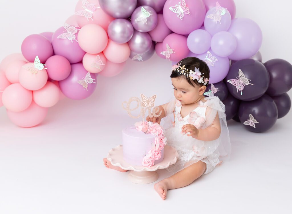 Girl cake smash pictures pink lavender purple balloon garland Brooklyn NYC