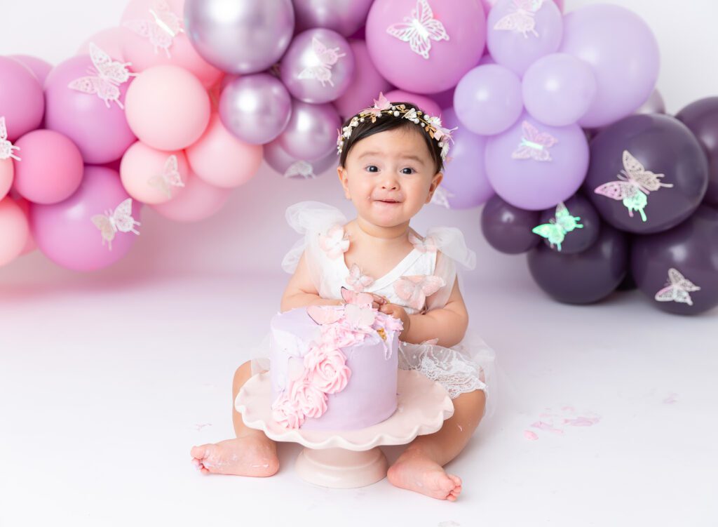 Brooklyn NYC cake smash baby girl photos pink lilac purple balloon garland 