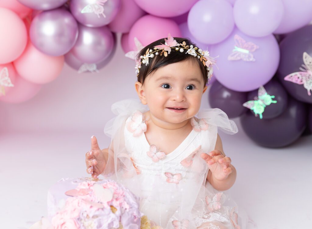 Brooklyn NYC cake smash baby girl photos pink purple balloon garland 