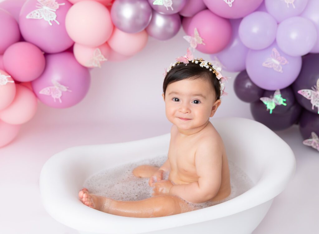First Birthday bubble bath baby girl pictures pink lilac purple balloon garland Brooklyn NY
