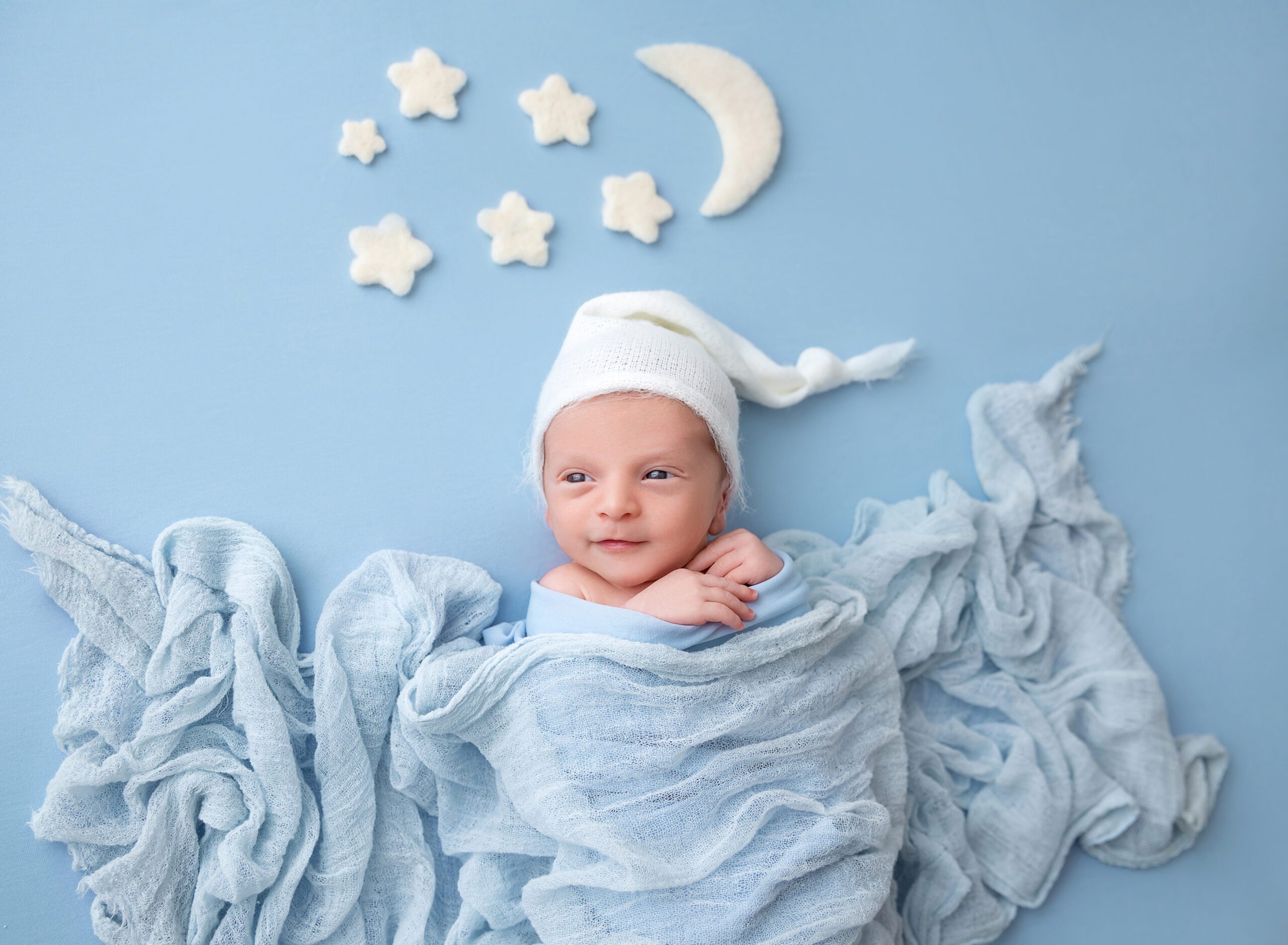 Newborn baby on blue blanket with stars portraits Brooklyn NY