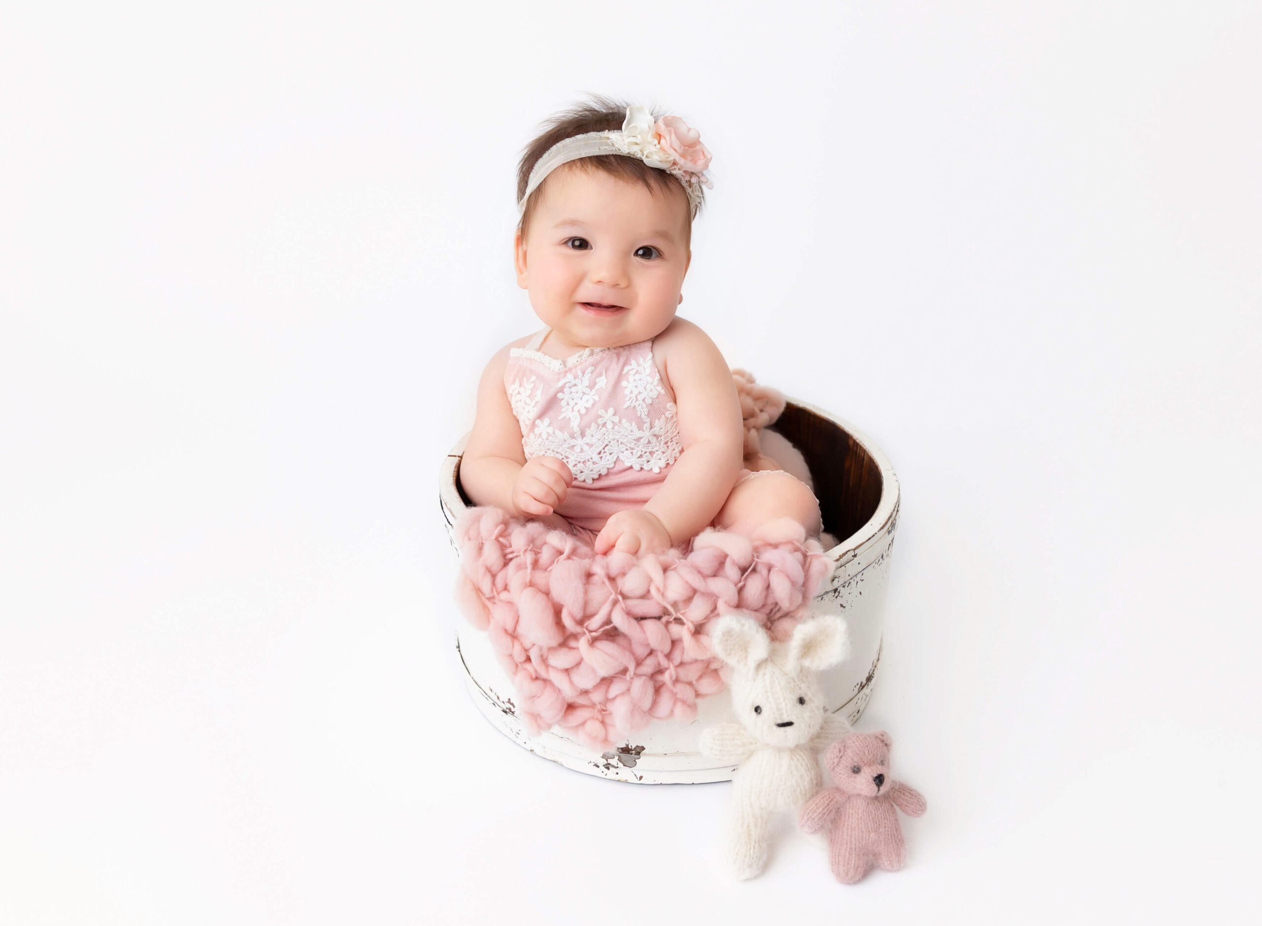 Baby girl smiling at her 6 months old baby photoshoot after baby friendly things to do in NYC
